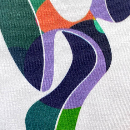 CALMECS T-SHIRT IN COLOR WHITE WITH COLORFUL ANGEL FRONT PRINT. CLOSE UP ANGEL SHAPE.