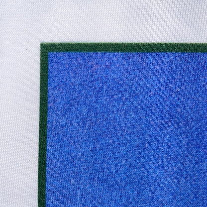 CALMECS T-SHIRT IN COLOR WHITE WITH BACK GRAPHIC PRINT. BLUE GRAPHIC CLOSE UP. 