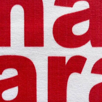 CALMECS T-SHIRT IN COLOR WHITE WITH RED MAIN CHARACTER FONT FRONT PRINT. CLOSE UP LETTERS.